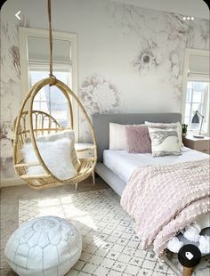 a bedroom with floral wallpaper and a hanging hammock chair in the corner