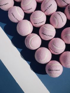 several pink tennis balls with names on them