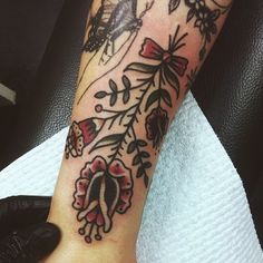 a woman's arm with flowers and butterflies on it