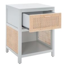 the side table has an open drawer and wicker basket on it's sides