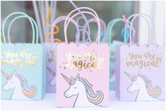 unicorn themed gift bags with the words you're magic written on them and rainbow colored handles