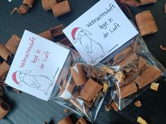 two bags of dog treats sitting next to each other on top of a table covered in food