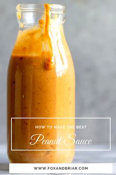 a jar filled with peanut sauce sitting on top of a table