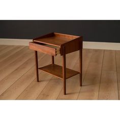 a small wooden table sitting on top of a hard wood floor