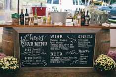 an outdoor bar with wine bottles and flowers