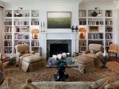 a living room filled with lots of furniture and bookshelves next to a fire place