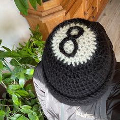 a crocheted hat with the number six on it