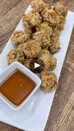 a white plate topped with meatballs and dipping sauce