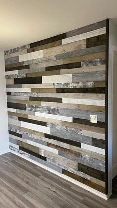 a wall made out of wooden planks in a room with hardwood floors and white walls