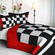 a black and white checkered quilted comforter with red accents on the bed