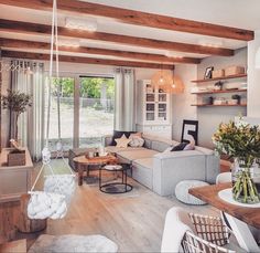 a living room filled with furniture and lots of windows