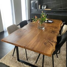 a wooden table with chairs around it