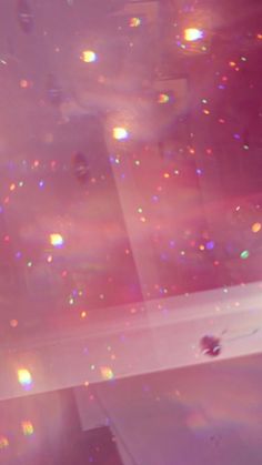 a bath tub sitting next to a window covered in lots of colorful bubbles and confetti