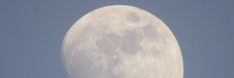 an airplane flying in front of the moon