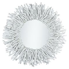 a circular mirror made out of white sticks