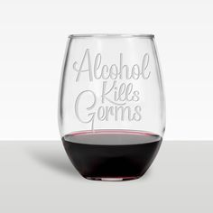 a wine glass with the words alcohol flies germs written in white on it