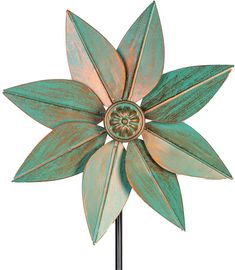 a green metal flower on a black stand