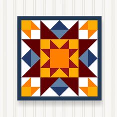 a colorful quilt hanging on the wall next to a white striped wallpaper with an orange, red and blue star design