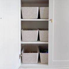 an organized closet with baskets and bins