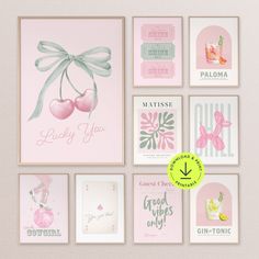 a bunch of cards that are hanging on the wall in front of a pink wall