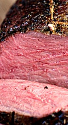 closeup of sliced meat on a wooden cutting board