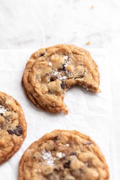 three chocolate chip cookies with one broken in half