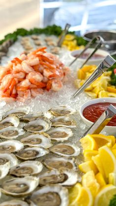 seafood platter with shrimp, oysters and lemon wedges