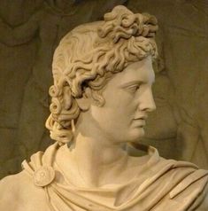 a close up of a statue of a woman with curly hair wearing a white dress