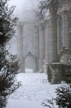 an old building with columns in the snow