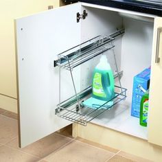 an open cabinet in the kitchen with cleaning products