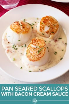 three scallops with bacon cream sauce on a white plate