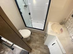 a bathroom with a toilet, sink and shower in it's own stall area