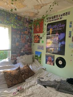 a bedroom with posters on the wall and bed