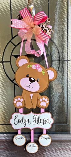 a wooden sign with a teddy bear on it's front and the name evelyn aleys