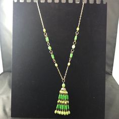 This listing is for a lightweight tassel necklace made in Hong Kong.  The necklace is made with gold tone metal and green colored resin beads.  It has a fun tassel dangle and a snap lock clasp. Size:  Approximately 26" in length; tassel is an additional 3" in length Condition:  Good condition for being vintage Want to purchase 3 or more items from my shop?  Please use the following coupon when you check out to receive 20% off! https://www.etsy.com/shop/elsysvintage?coupon=ELSYSDISCOUNT *Please be aware the items I am selling are vintage, which means they are old and with anything old there will be some wear due to their age.  I try to photograph and describe the items I sell as good as I possibly can.  If you have any questions please feel free to contact me. Please check out my other item Snap Lock, Green Beads, Resin Beads, Boho Stil, Beaded Dangles, Green Bead, Vintage 1970s, Gold Tone Metal, Boho Style