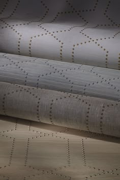 three different types of upholstered fabric with gold dots on the top and bottom