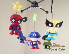 three stuffed toys hanging from a ceiling in the shape of avengers and spider - man