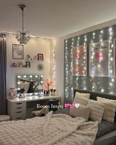 a bedroom with lights on the walls and a bed in front of a mirror that is lit up