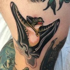 a close up of a person's leg with a tattoo on it and an image of a bird