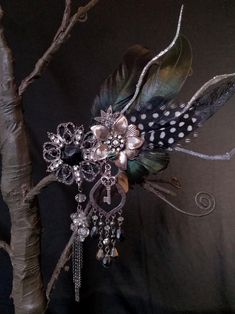 This one of a kind fascinator is an eclectic assembly of findings and embellishments and is the perfect accessory to any costume be it steampunk, burlesque, RenFaire, flapper, fairy or anytime you're feeling fabulous! There is a subtle green shimmer to the feathers on this piece, which is highlighted with a tiny green ladybug tucked in amidst the glitter and sparkle of silver flowers and faceted rhinestone. Additional embellishments can include buttons, jewels, feathers, beads, silk flowers, filigree findings and more.  The piece is backed with a comfortable felt lining in matching colors, and sturdy alligator clips for staying in your hair or attaching to a hat or other clothing items.  All my pieces are completely unique, handmade creations. The item pictured is the item that will be shi Steampunk Burlesque, Fascinator Hair, Feather Fascinator, Feather Fascinators, Fantasy Fairy, Costume Hats, Silver Flowers, Silk Flowers, Costume Accessories