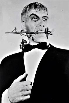 a man in a tuxedo with barbed around his mouth