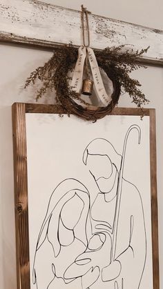 a drawing hanging on the wall next to a wooden frame