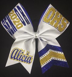 "This is a firm structured bow made for durability! Custom color request accepted; just send me a message!  3\" width grosgrain overlaid with White Shimmer accented withGlitter and Rhinestones. Bow measures approx 7.5-8\"x7.5-8\" All my bows are made with Medium length tails, if you prefer shorter or longer tails please contact me! All bows have seamless no-break pony attached; there is an option to add a 2nd pony which will be a loose ponyo for securing the ponytail before putting the bow in. Team Orders of 10 or more ship for FREE Ask about team orders! Specializing in custom cheer bows for competitive cheer teams and schools! Cheer bows are not limited to cheerleaders only, as I do team bows for color guard, softball, volleyball etc. All my bows have Seamless No-Break ponies and are mad Senior Cheer Bows, Bling Cheer Bows, Basketball Cheer, Custom Cheer Bows, Basketball Cheers, School Cheer, High School Cheer, Royal Yellow, Competitive Cheer