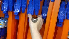 a hand pointing at orange and blue shelves