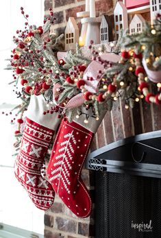 stockings hanging from the fireplace with christmas decorations