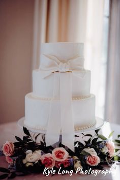 a white wedding cake sitting on top of a table