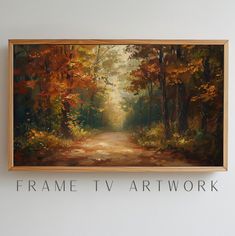 a painting hanging on the wall above a sign that says frame tv art work with an image of a forest