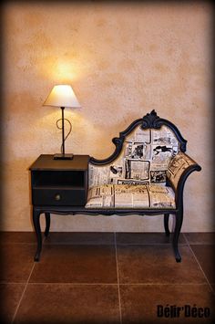 a small table with a lamp on it next to a couch