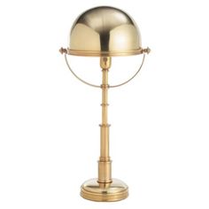 a brass colored table lamp on a white background