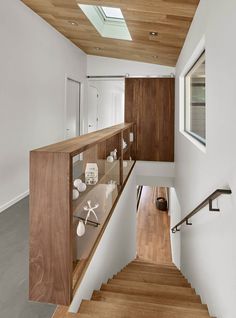 Wooden shelf next to the staircase also doubles as a railing - Decoist Doors Entry, Hardwood Doors, White Panel, Staircase Railings, Coastal Living Rooms, House Stairs, Stair Railing, Staircase Design